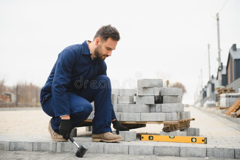 Pavement. Laying paving stones. Cube, openwork plate stock photos