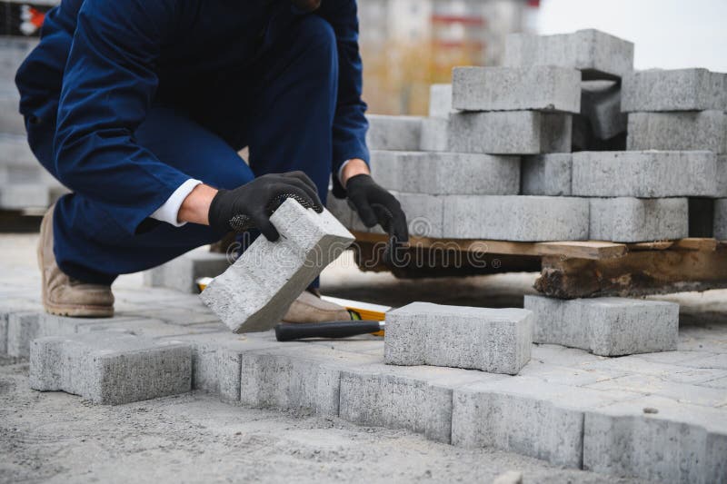 Pavement. Laying paving stones. Cube, openwork plate stock photo
