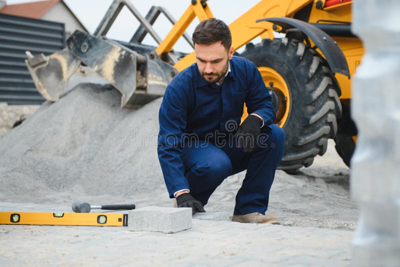 Pavement. Laying paving stones. Cube, openwork plate stock photos