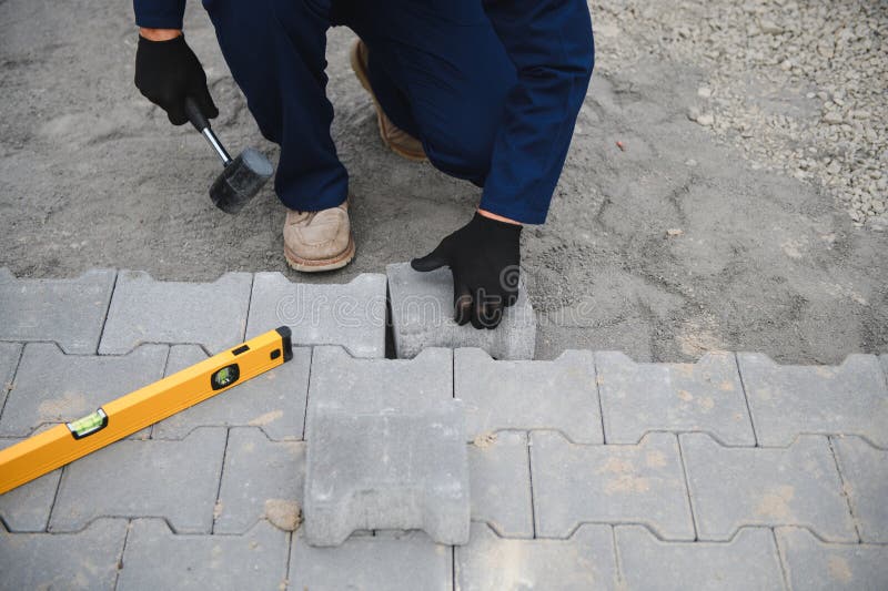 Pavement. Laying paving stones. Cube, openwork plate stock photography