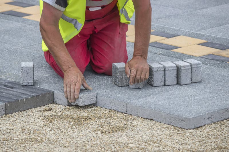 Mason hands laying paver bricks, paver making sidewalk. Selective focus and shallow dof. Bricklayer tiler stock images, royalty-free photos and pictures