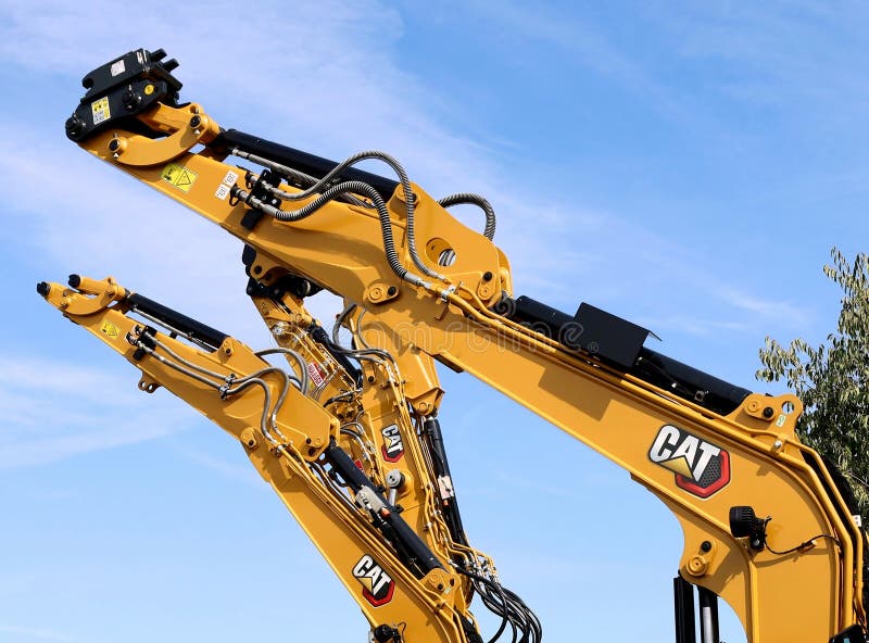 Caterpillar Excavator Booms Against Blue Cloudy Sky Editorial Image caterpillar-excavator-booms-against-blue-cloudy-sky-editorial-image
