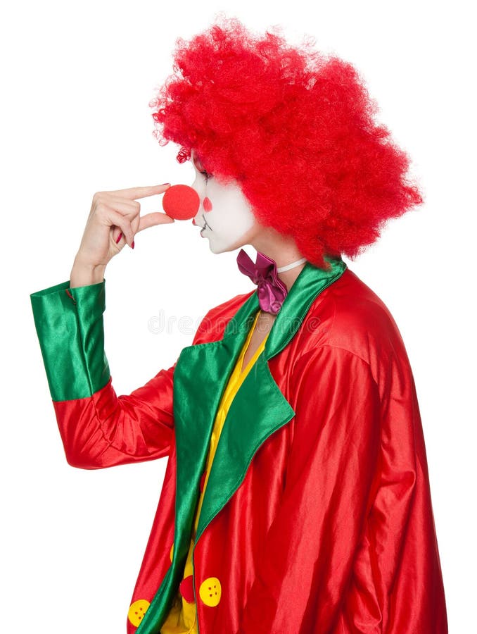 A female clown with colorful clothes and makeup squeezing her nose. A female clown with colorful clothes and makeup squeezing her nose