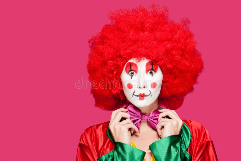 A female clown with colorful clothes and makeup. A female clown with colorful clothes and makeup