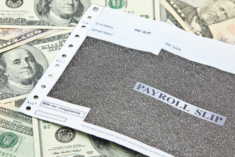 Payroll slip on pile of US dollar banknotes