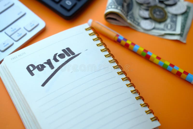 Payroll word on notepad with calculator on color background. royalty free stock photo