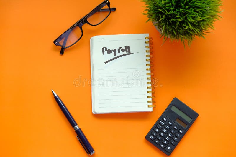 Payroll word on notepad with calculator on color background.