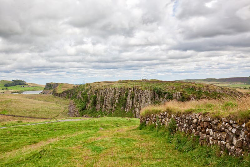 The verdant Northumberland countryside of England with sections of Hadrian`s Wall visible. The verdant Northumberland countryside of England with sections of Hadrian`s Wall visible.