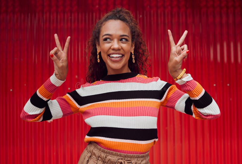 Peace sign, comic and black woman against red wall in the city of Amsterdam for holiday, travel and adventure. Thinking stock images