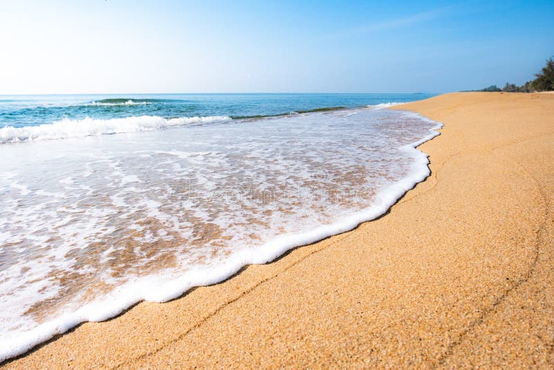 A peaceful beach scene in Thailand, exotic tropical beach landscapes and blue sea under a blue background. Relaxing summer holiday