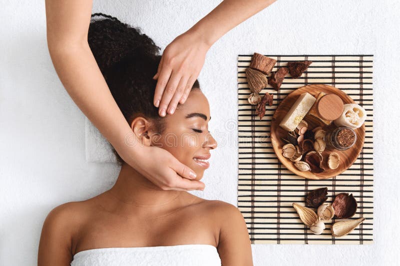 Joyful Black Lady Having Hot Stone Massage At Luxury Spa Stock Image