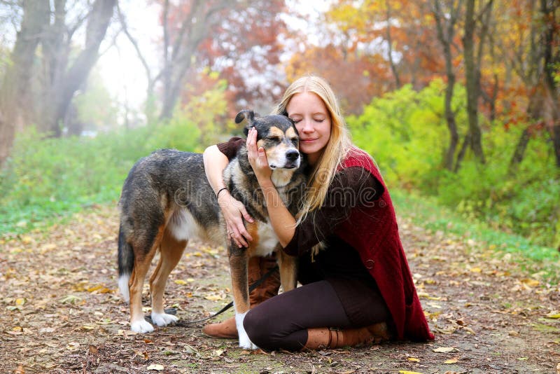 Peaceful Happy Woman Hugging German Shepherd Dog While Walking i