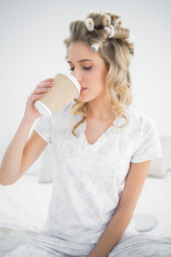 peaceful-pretty-blonde-wearing-hair-curlers-drinking-coffee-sitting-cosy-bed-33435333.jpg