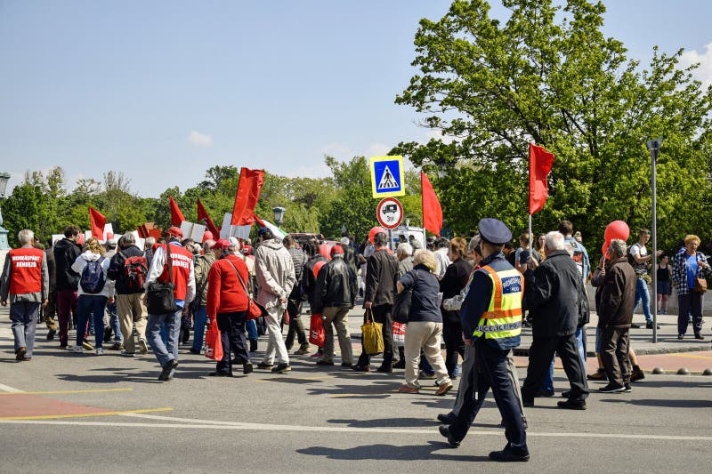 Peaceful procession of people with red flags and balloons on the main street. royalty free stock images Peaceful procession of people with red flags and balloons on the main street. royalty free stock images