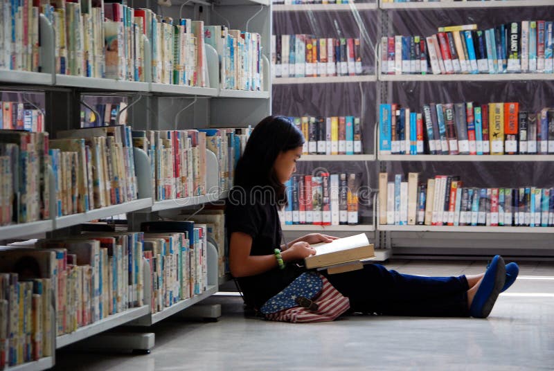 Peacefully reading in the library stock photos Peacefully reading in the library stock photos