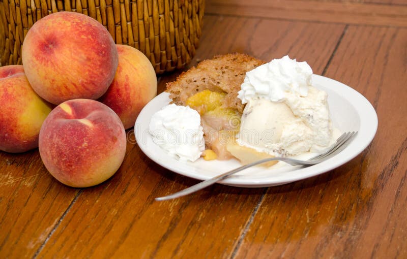 Fresh Michigan peaches create sweet peach cobbler, topped with ice cream and a little fresh cream. Fresh Michigan peaches create sweet peach cobbler, topped with ice cream and a little fresh cream