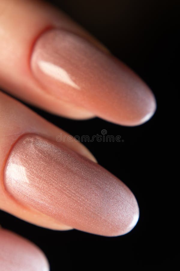 Glossy Top Coat on a Peach-colored Magnetic Cat-eye Manicure Stock ...