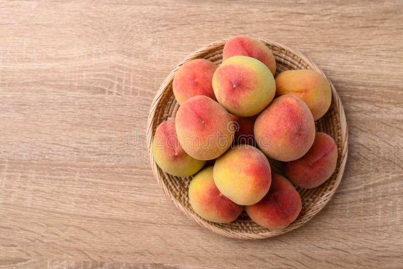 Peach Fruit in Basket on Wooden Background, Top View Stock Image