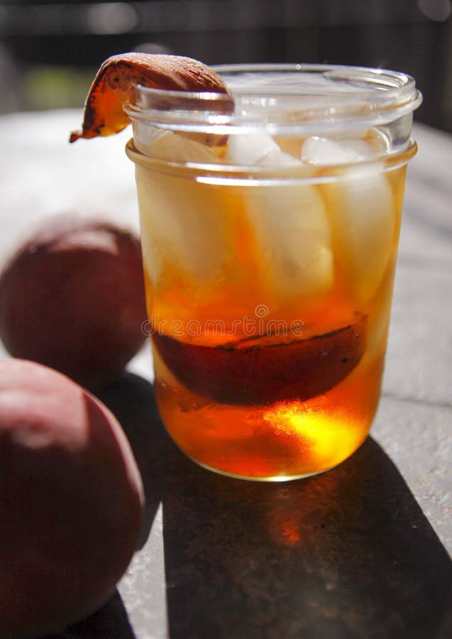 Ice tea spiked with bourbon and grilled peaches served in an old-fashioned jar type glass a great thirst quencher on a hot June Summer day 72806862. Ice tea spiked with bourbon and grilled peaches served in an old-fashioned jar type glass a great thirst quencher on a hot June Summer day 72806862