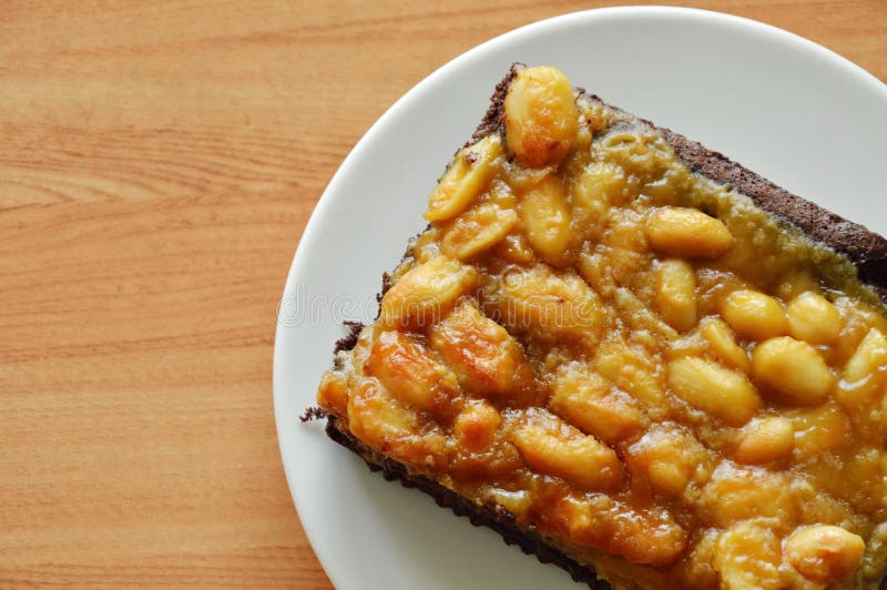 Peanut Butter Caramel Topping Dark Chocolate Cake on Dish Stock Image