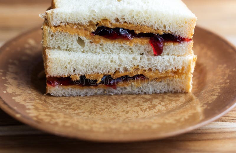 Peanut Butter and Jelly Sandwich on White Bread, Cut in Half and ...