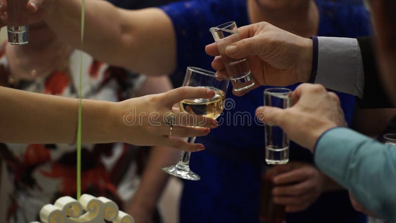 peaople party wedding cheers shot glasses friends toasting happy group raise toast outdoor cafe 100757191