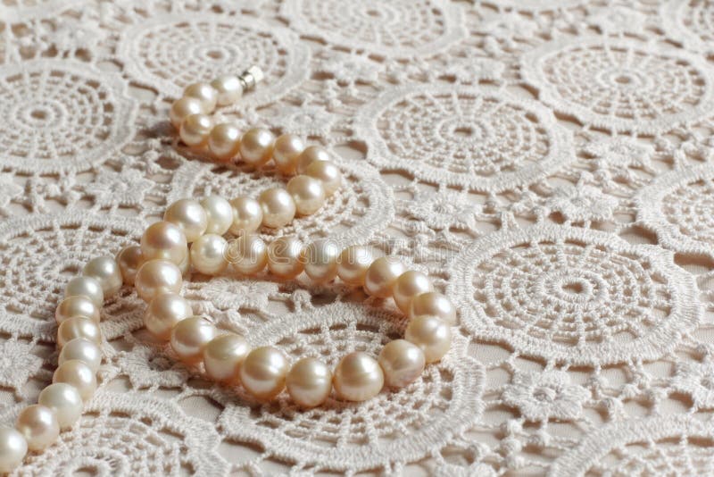 Pearl necklace on lace fabric