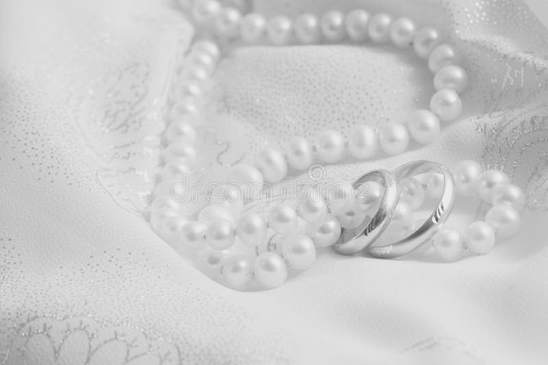 Pearls and wedding bangs. Black-and-white.