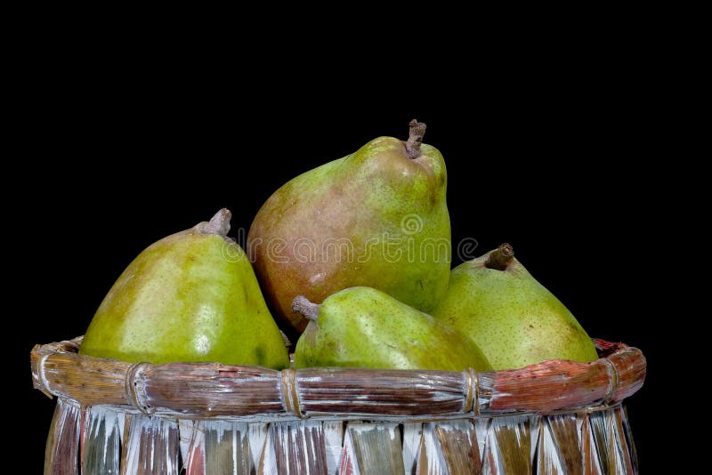 Pears in a basket isolated on a black background