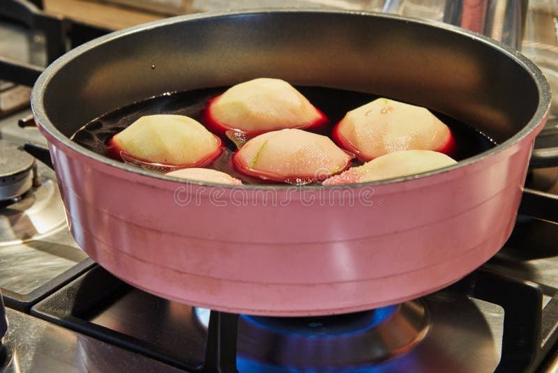 Pears are Boiled in Red Syrup with Wine on Gas Stove Stock Image
