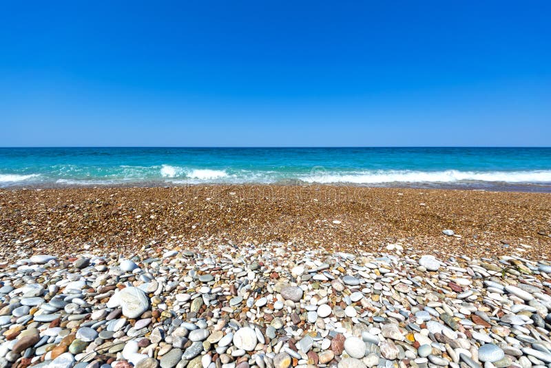 Pebble beach at Greece stock image. Image of pebble, foam 98488387