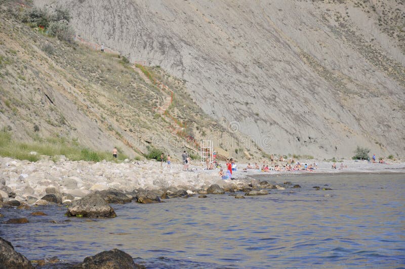 The pebble beach with people stock photography The pebble beach with people stock photography