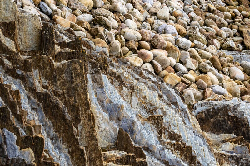 Pebbles and Boulders on the Seashore. Rocky Ocean Shore Stock Image