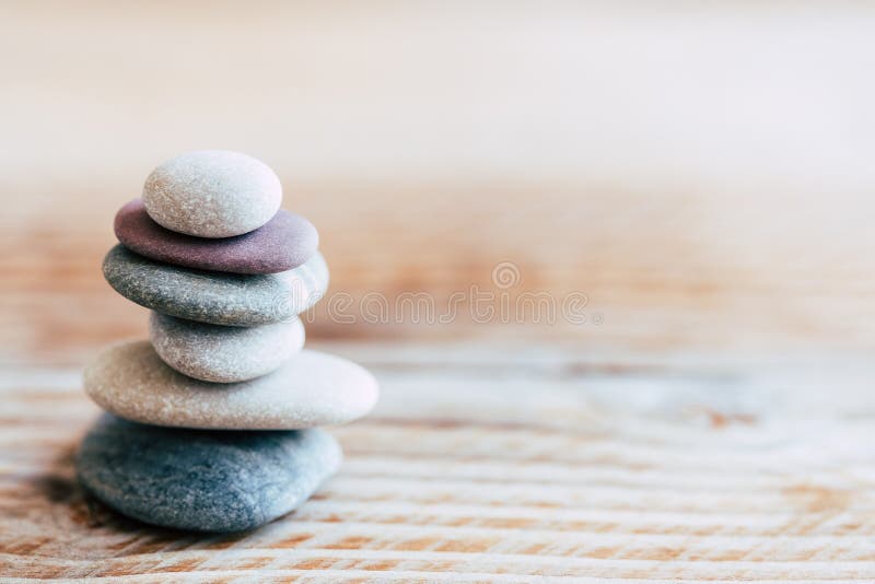 Pebbles stacked on a wooden background - Atmosphere of serenity