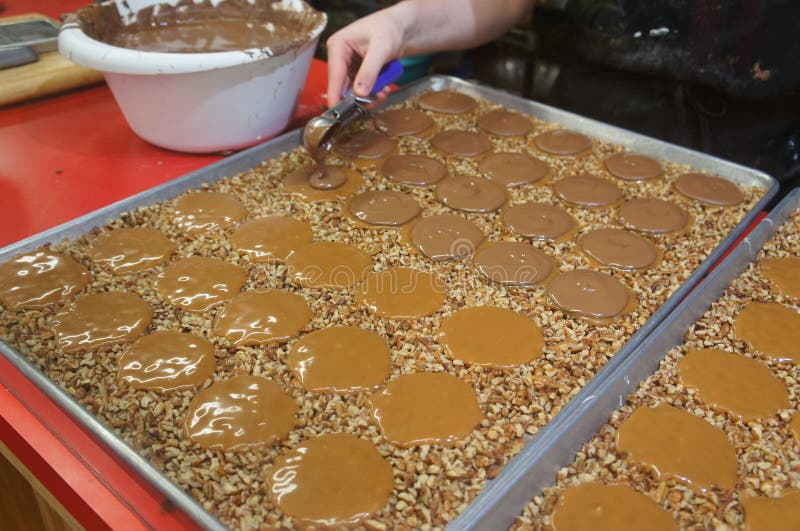 Traditional southern pecan pralines and milk chocolate gophers being made in a sweet shop in Savannah, Georgia, USA. Traditional southern pecan pralines and milk chocolate gophers being made in a sweet shop in Savannah, Georgia, USA