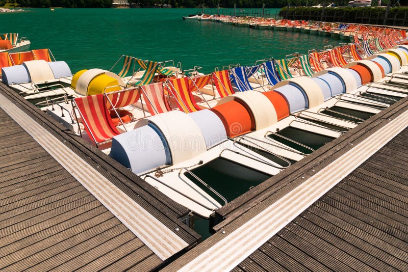 Pedal Boat Parked in a Long Line at the Dock. Stock Photo Image of