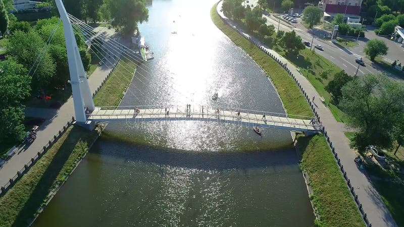 Pedestrian bridge over the river, white beautiful pedestrian bridge across the river stock video footage
