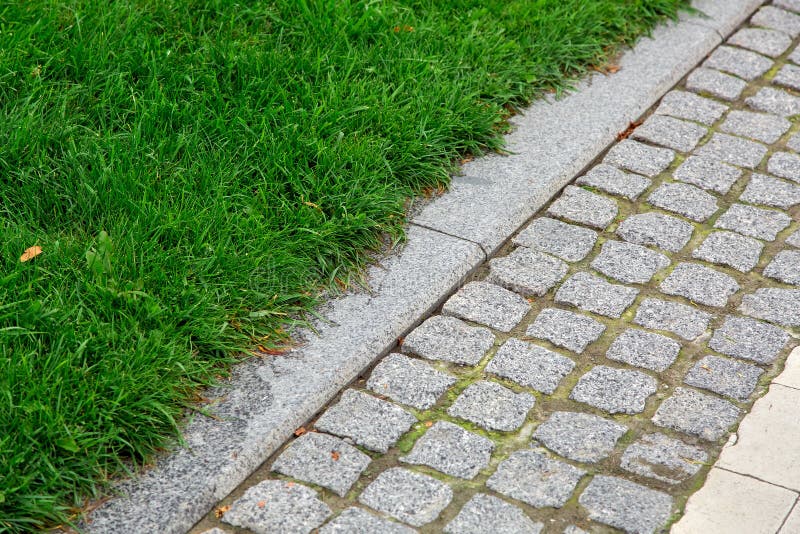 A pedestrian pavement made of stone cobble and granite tiles. stock photos A pedestrian pavement made of stone cobble and granite tiles. stock photos