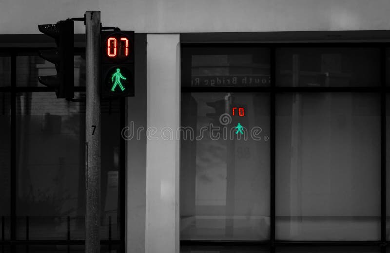 Pedestrian signals on traffic light pole. Pedestrian crossing sign for safe to walk in the city. Crosswalk signal. Green traffic