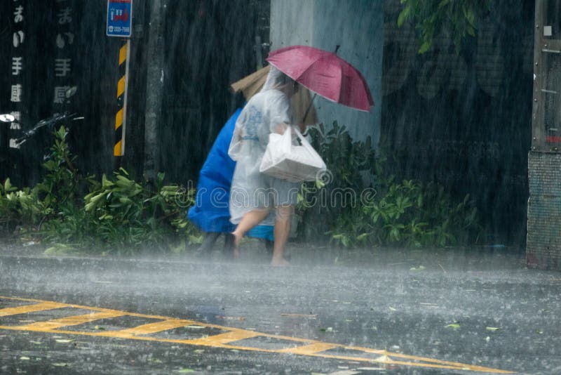 Pedestrians crossing street during Typhoon Megi