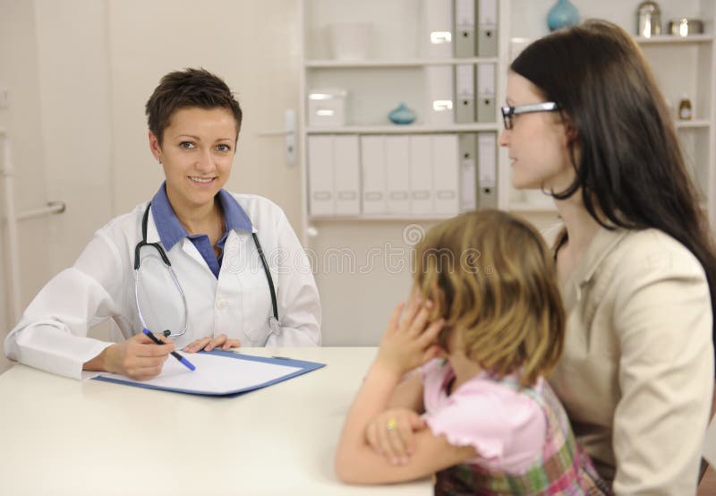 Pediatra che comunica con madre e bambino immagini stock libere da diritti