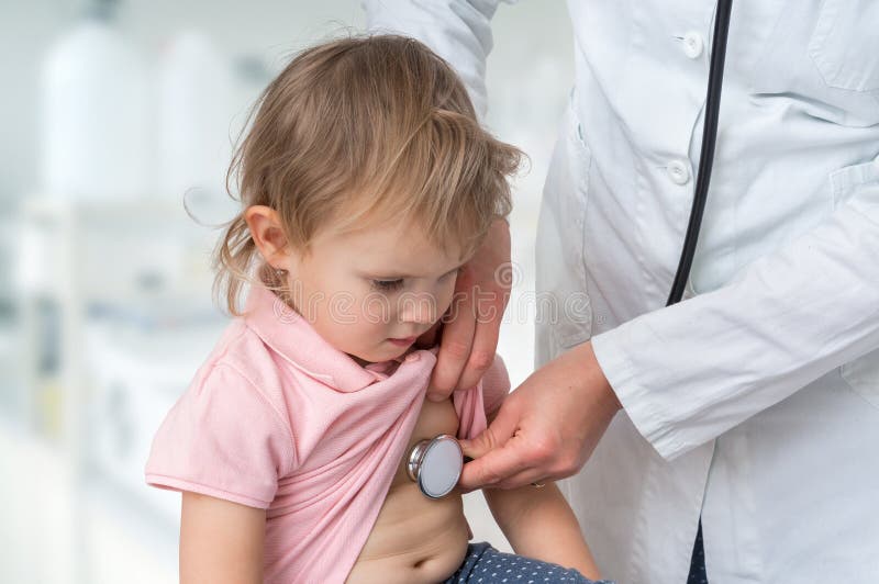 Pediatrician doctor examining a little girl by stethoscope royalty free stock photo Pediatrician doctor examining a little girl by stethoscope royalty free stock photo