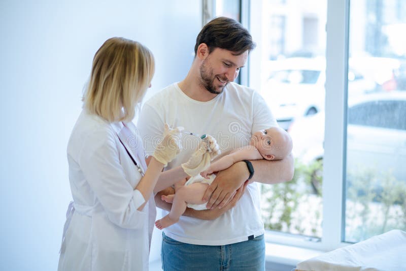 Experienced Neonatal Doctor Preparing To Vaccinate The Child Stock