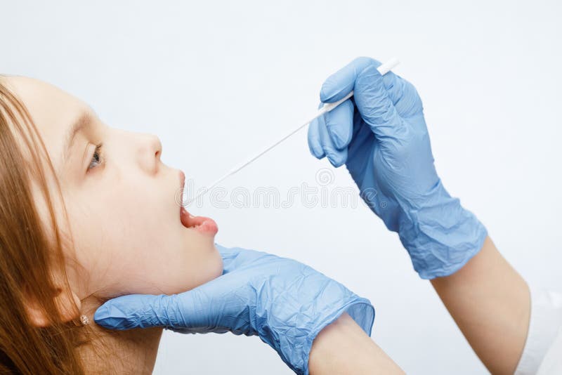 Pediatrician taking saliva test sample