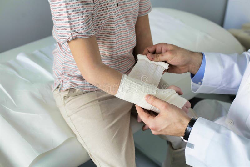 Pediatrician Tying Bandage on Boy Hand at Clinic Stock Photo Image of