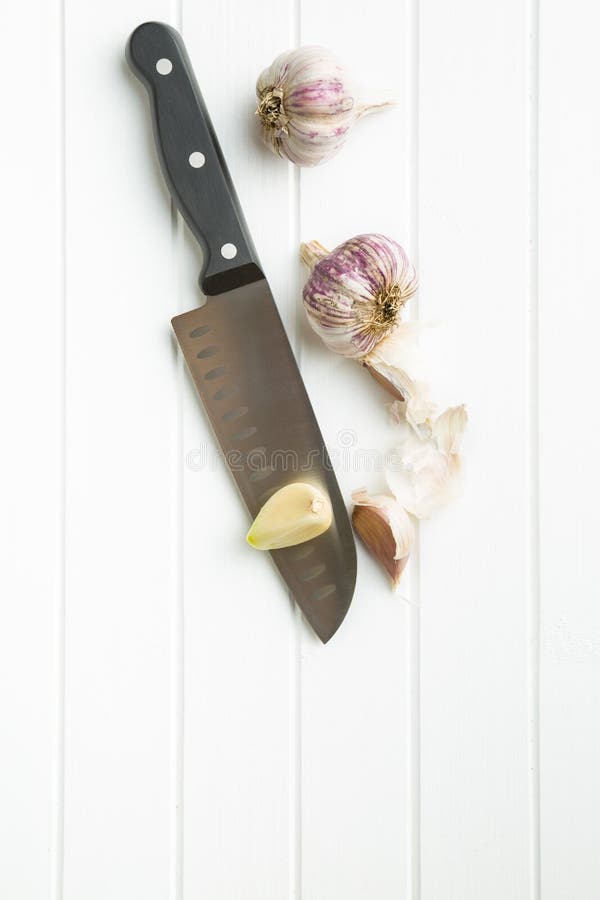 Peeled garlic on knife stock image. Image of food, life 76533571