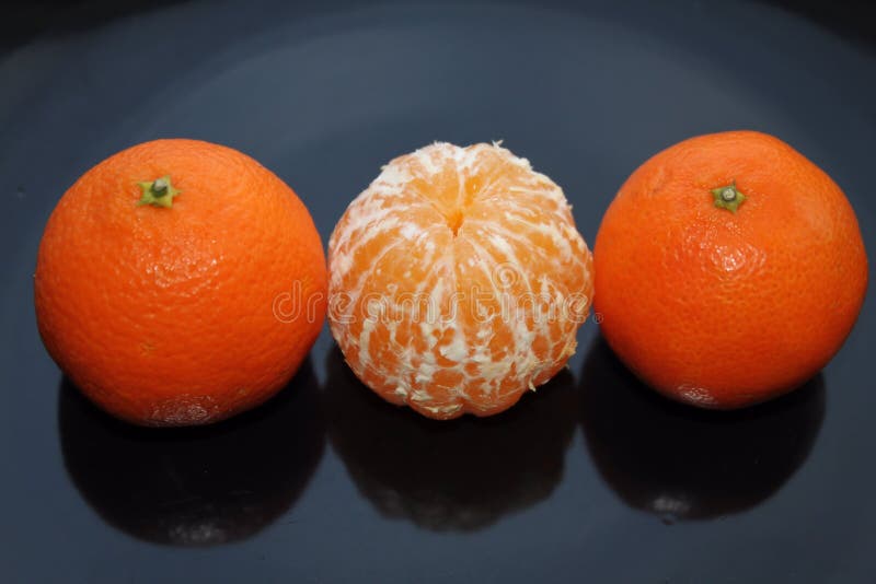 Peeled Mandarin between Whole Mandarins Stock Photo Image of food