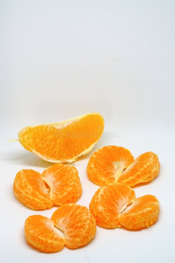 Peeled orange and mandarin slices on white isolated background