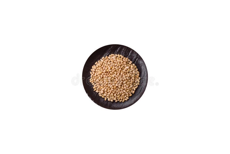 Peeled pine nuts in a bowl on a white background stock photography