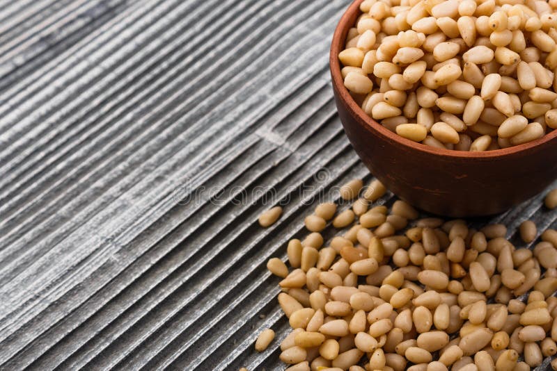 Peeled pine nuts on a rustic background stock photo